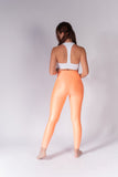 Legging brillante efecto cuero control abdomen color melón neón